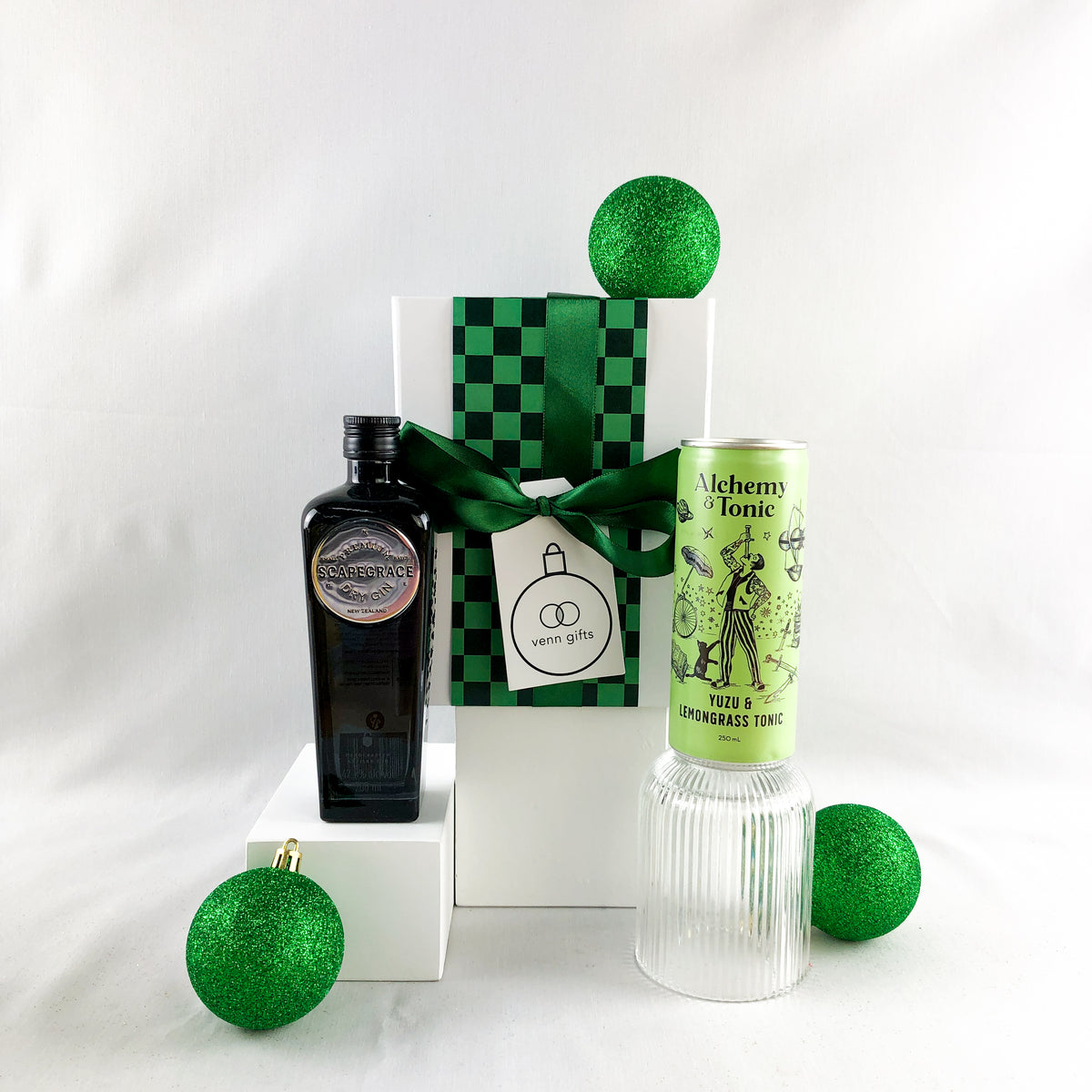 Scapegrace, Alchemy & Tonic 7 reeded glass in front of a white giftbox with black ribbon against a white background by Venn Gifts.