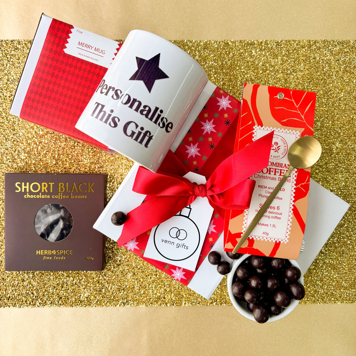 Coffee snacks and customised mug against a gold background by Venn Gifts.