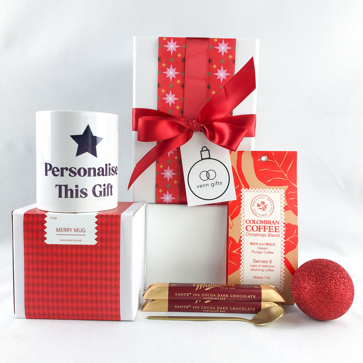 Personalised mug, whittakers chocolates and coffee within a white gift box with red wrapping and red bow by Venn Gifts.