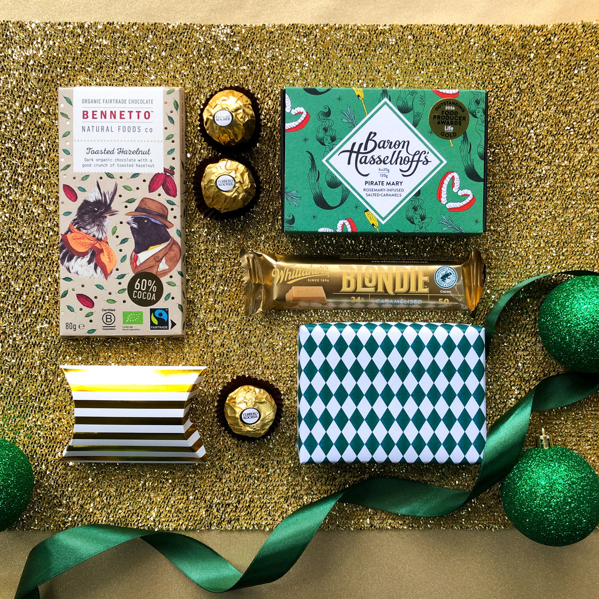 Chocolates by Baron Hasselhoff, Bennetto, Whittaker's, Ferrerro Rocher & Chocolate Brownie against a gold background by Venn Gifts.