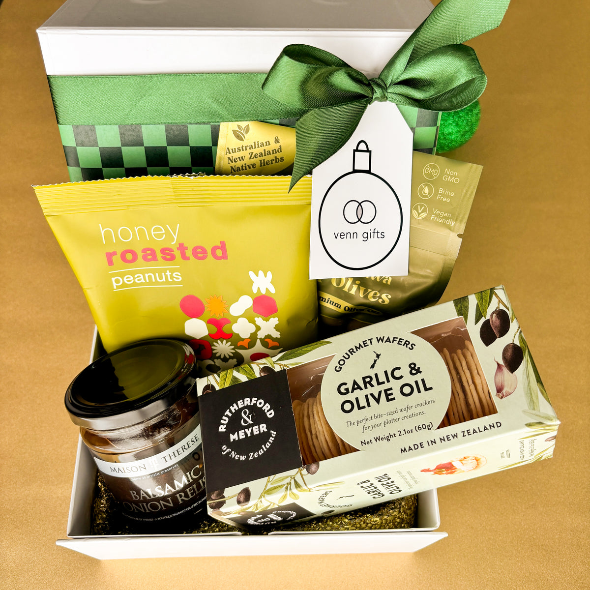 Gift box of savoury snacks and relish inside a white gift box with green bow by venn gifts